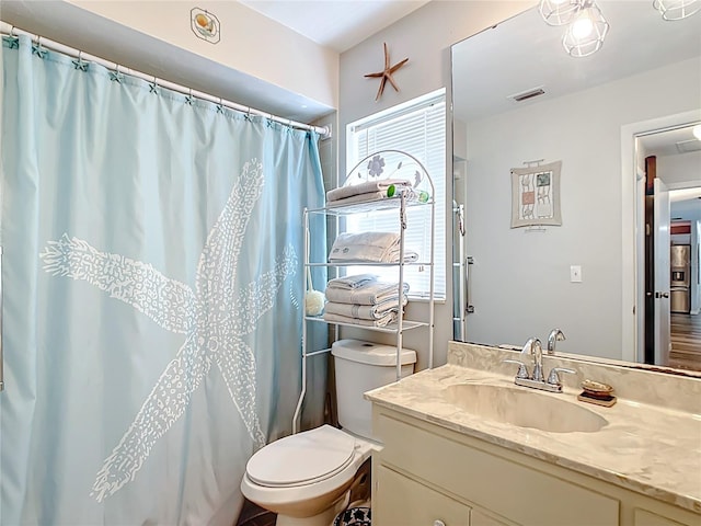 full bathroom featuring visible vents, plenty of natural light, toilet, and vanity