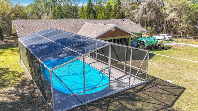 pool featuring a lanai, a patio, and a yard