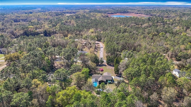 birds eye view of property featuring a view of trees