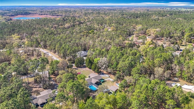 birds eye view of property with a view of trees