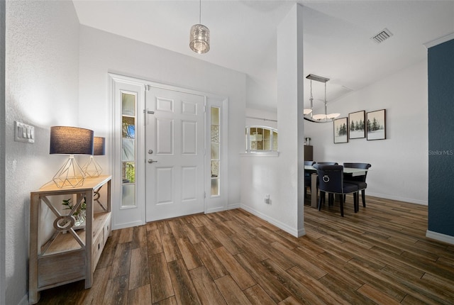 foyer featuring dark wood-type flooring, baseboards, and visible vents