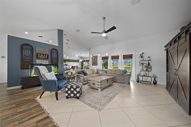 living area featuring a ceiling fan, visible vents, high vaulted ceiling, recessed lighting, and a barn door