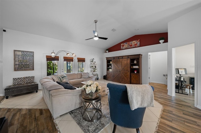 living area featuring french doors, wood finished floors, ceiling fan, and vaulted ceiling