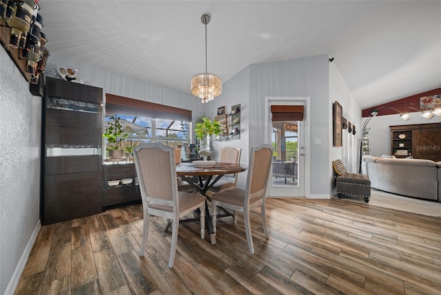 dining room featuring lofted ceiling, plenty of natural light, and wood finished floors