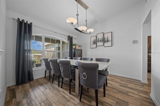 dining room featuring baseboards and wood finished floors