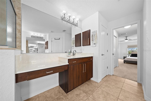 ensuite bathroom with tile patterned floors, visible vents, ensuite bathroom, a textured ceiling, and vanity