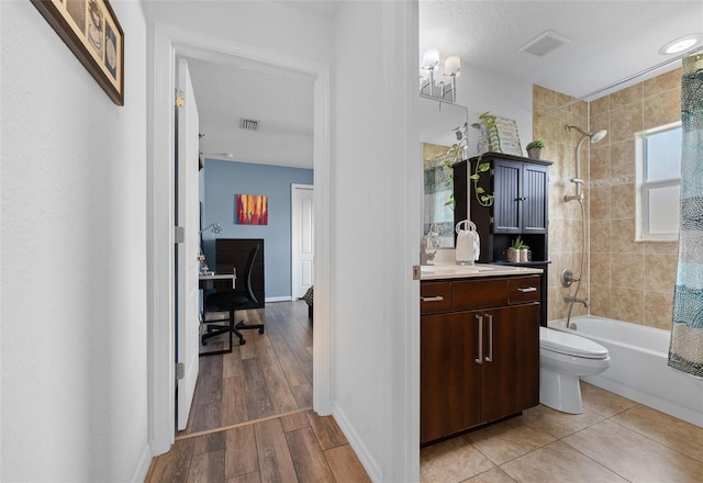 full bath featuring visible vents, shower / bathtub combination with curtain, vanity, and toilet