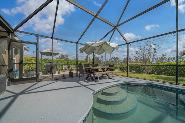 outdoor pool with glass enclosure and a patio