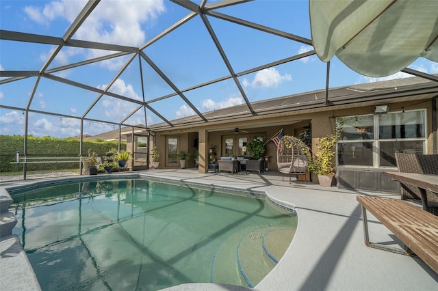 outdoor pool with an outdoor living space, glass enclosure, and a patio