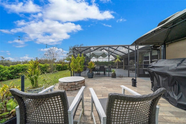 view of patio with glass enclosure and outdoor dining area