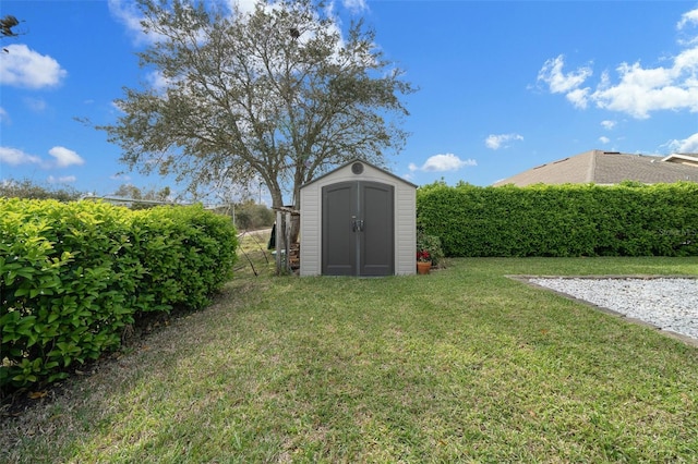 view of yard featuring an outbuilding and a shed