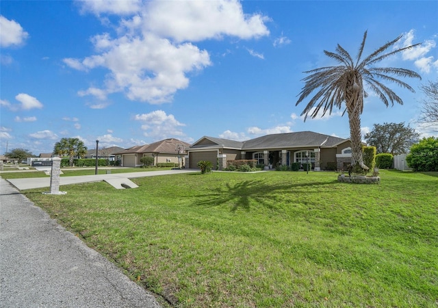 ranch-style house with concrete driveway, an attached garage, and a front yard