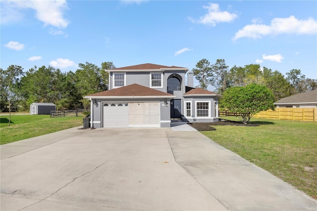 view of front of home with stucco siding, concrete driveway, a front lawn, and fence