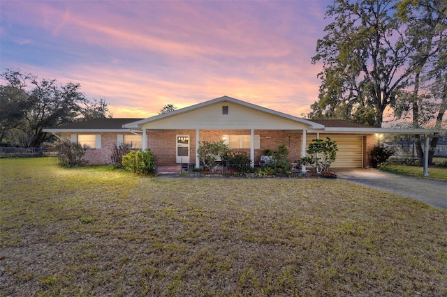 view of front of house featuring driveway, brick siding, covered porch, and a front yard