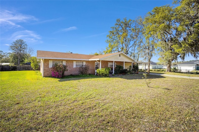 single story home with a front yard, fence, and brick siding