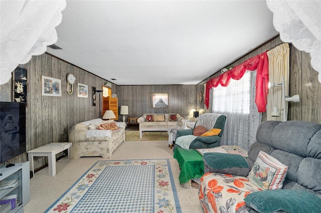 living area featuring visible vents, carpet floors, and a textured ceiling