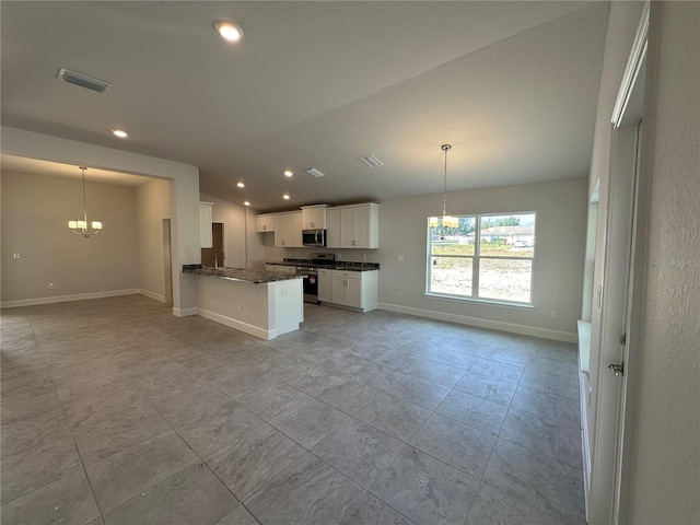 kitchen featuring visible vents, stainless steel appliances, white cabinets, a notable chandelier, and open floor plan