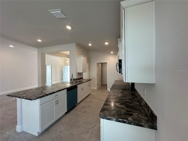 kitchen featuring dishwashing machine, dark stone countertops, visible vents, a sink, and white cabinetry