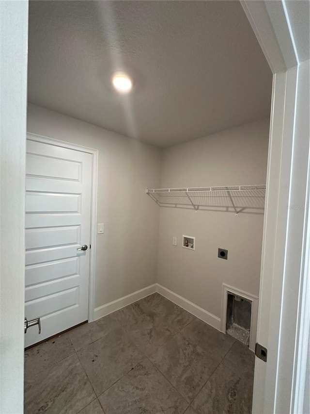 laundry room with laundry area, hookup for a washing machine, hookup for an electric dryer, and baseboards