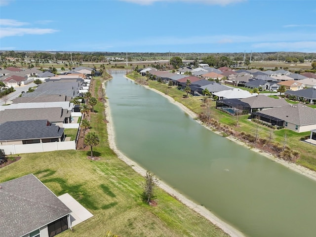 drone / aerial view with a residential view and a water view