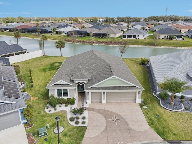 drone / aerial view with a residential view and a water view