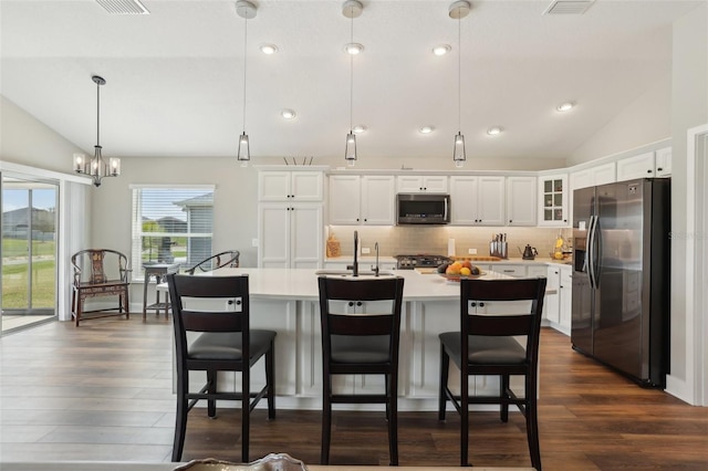 kitchen featuring light countertops, lofted ceiling, appliances with stainless steel finishes, dark wood-style floors, and white cabinetry