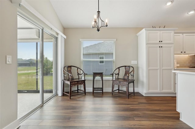 sitting room with baseboards, recessed lighting, dark wood-style flooring, a wall mounted air conditioner, and a chandelier