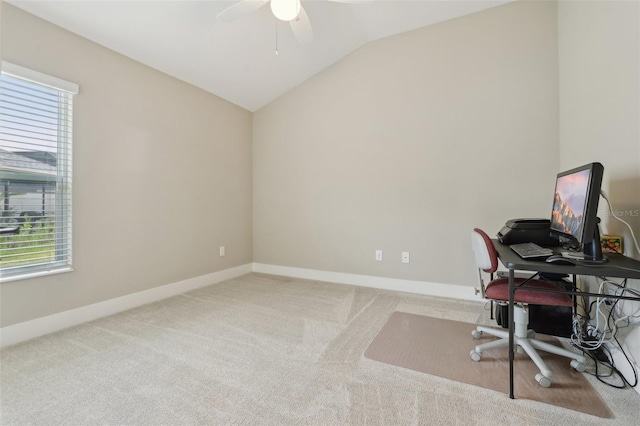 carpeted office featuring a wealth of natural light, baseboards, lofted ceiling, and a ceiling fan