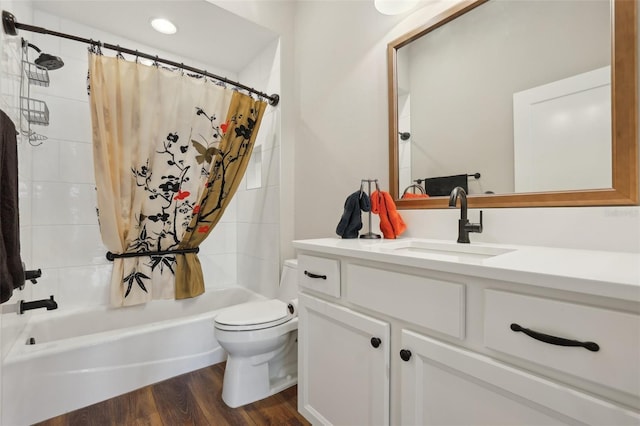 bathroom featuring shower / bath combo with shower curtain, toilet, vanity, and wood finished floors