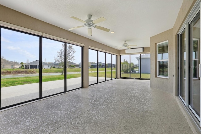 unfurnished sunroom featuring a residential view and an AC wall unit