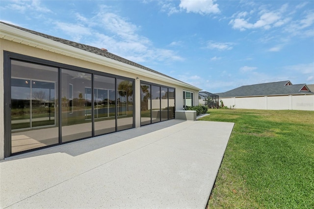 rear view of house featuring a patio area, a lawn, and fence