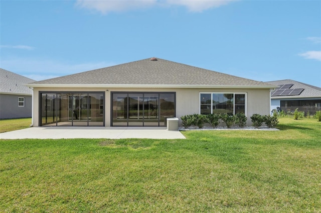 back of house featuring stucco siding, a lawn, a patio, and a shingled roof