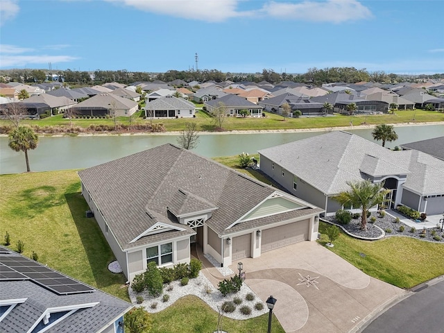 birds eye view of property featuring a residential view and a water view