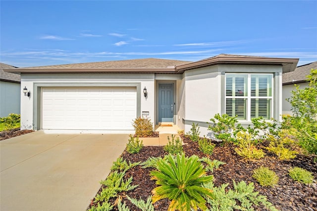 single story home with a garage, concrete driveway, and stucco siding