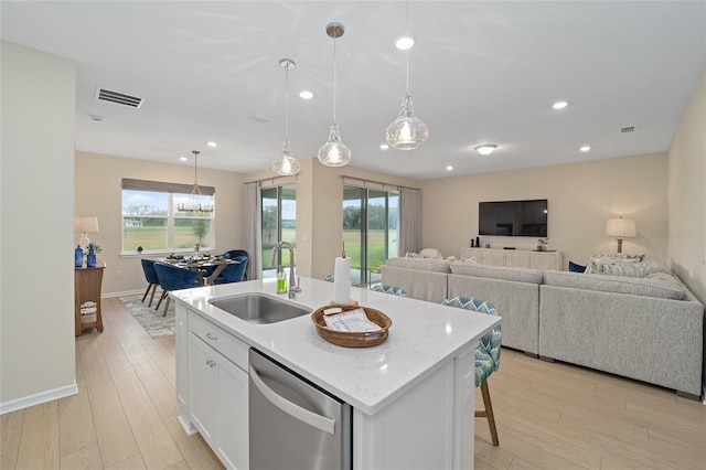 kitchen featuring visible vents, white cabinetry, a sink, light wood-style floors, and dishwasher