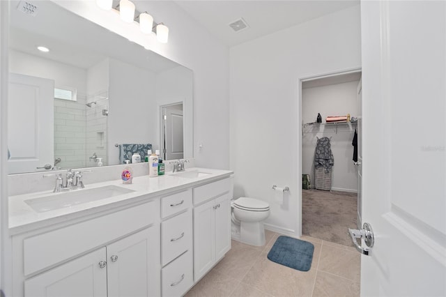 full bath with visible vents, a shower stall, and a sink