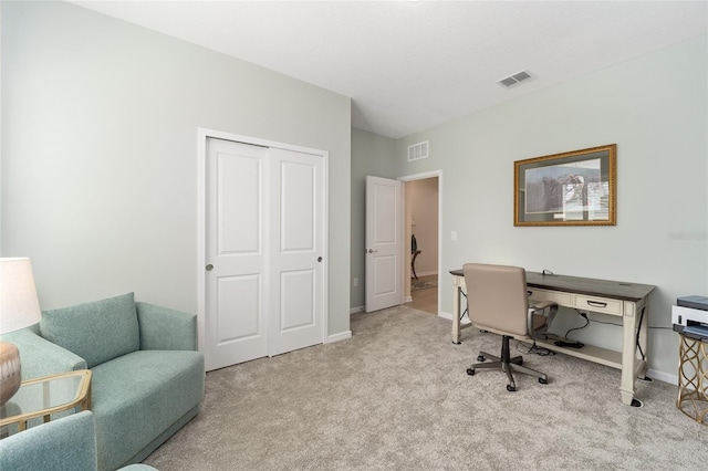 office area with visible vents, baseboards, and carpet