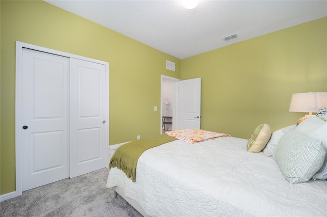 bedroom with a closet, visible vents, baseboards, and carpet