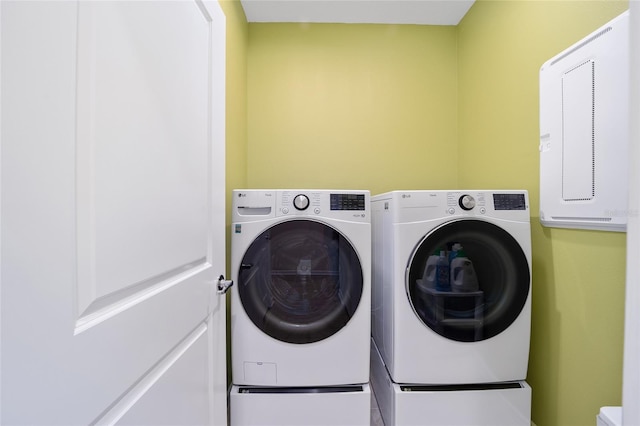 washroom with washing machine and clothes dryer and laundry area