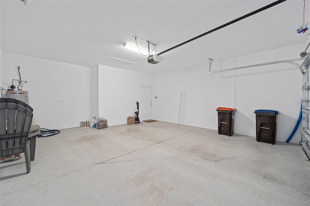 garage featuring water heater and a garage door opener