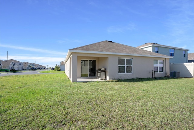 4931 SW 88th Pl, Ocala, FL 34476 - back of property featuring central AC unit, stucco siding, a yard, and fence