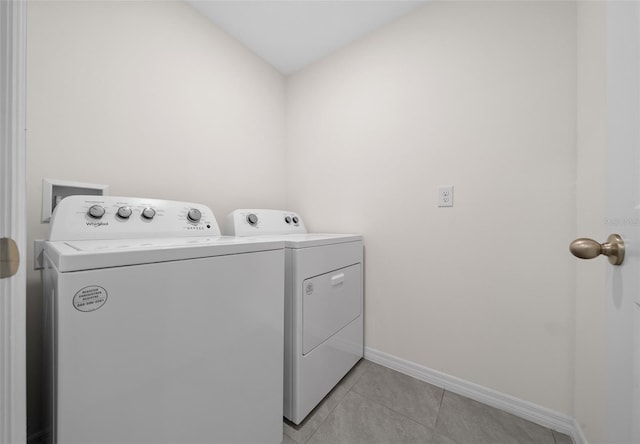 4931 SW 88th Pl, Ocala, FL 34476 - clothes washing area featuring baseboards, separate washer and dryer, light tile patterned flooring, and laundry area