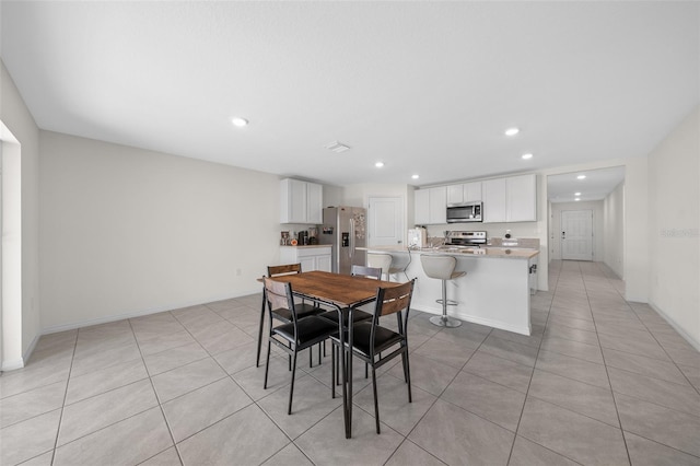 4931 SW 88th Pl, Ocala, FL 34476 - dining area with light tile patterned flooring, recessed lighting, and baseboards