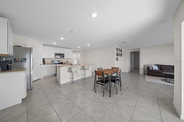 4931 SW 88th Pl, Ocala, FL 34476 - dining room with light tile patterned floors, visible vents, and recessed lighting
