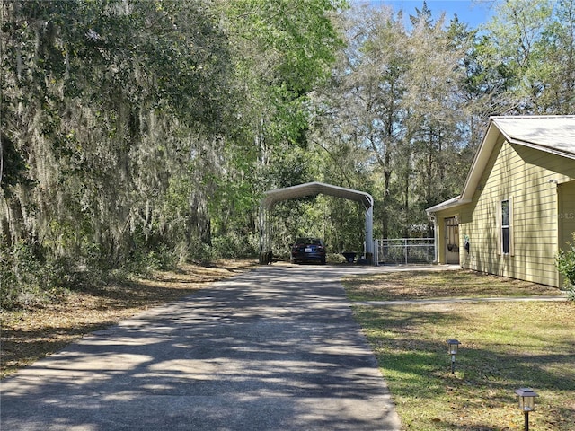 view of home's exterior featuring a detached carport and driveway