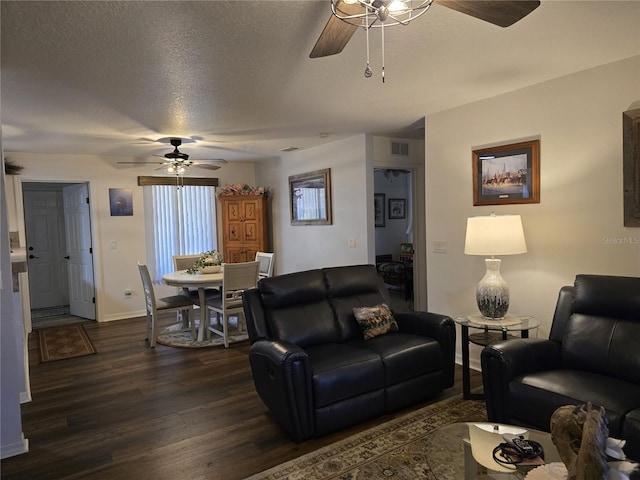 living room featuring baseboards, visible vents, dark wood finished floors, ceiling fan, and a textured ceiling