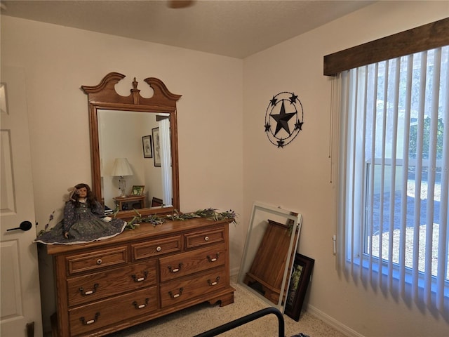 bedroom with baseboards and light speckled floor