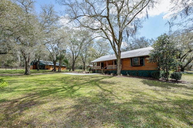 view of yard featuring covered porch