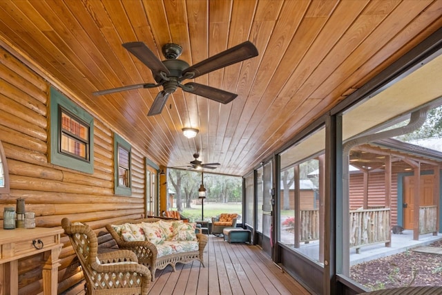 sunroom / solarium featuring wooden ceiling and a ceiling fan