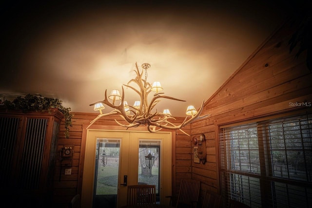 room details featuring an inviting chandelier and french doors